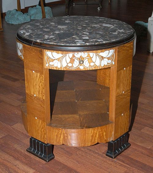 SMALL SALON TABLE, Mercier Frères Paris, ca. 1920. Sapele veneer. Cylindrical form with one drawer. Ebonised fluted feet. Finely inlaid with flowers in ivory and with marble top. D. 61, H. 61 cm.