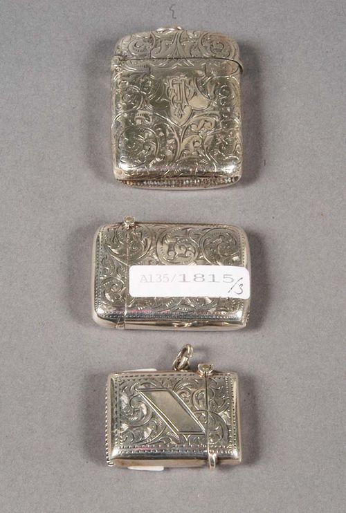 THREE SILVER MATCH BOXES Birmingham, 1893-1914. Maker's marks, year stamps for 1893-94, 1901, and 1913-14. With hinged lid, engraved with foliate decoration, the front with cartouche, one with initials, 'DTJ', two with eyelet for hanging, L 3.5cm, 4.5 cm, 5 cm.