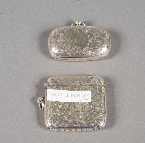 TWO SILVER MATCH BOXES, Chester, 1903-1910. Maker's mark. Year stamps 1903-04, and 1909-10. Engraved with trailing leaves, each box with a cartouche for monogram, eyelet for hanging. H 4.5cm and 3 cm.