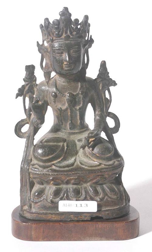 SEATED BODHISATTVA.China, Ming Dynasty, H 18 cm. Dark bronze, on the back: traces of gold over dark-brown lacquer. Two lotus flowers are opening next to the shoulders, a shawl is draped over the double lotus plinth. Wooden plinth.
