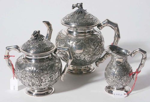 TEA MUG, MILK CAN AND SUGAR BOWL.China, 19th century. H 10-16 cm. Embossed silver with dragons among the clouds. Handles, spouts and lid knobs in the shape of bamboo. (3)