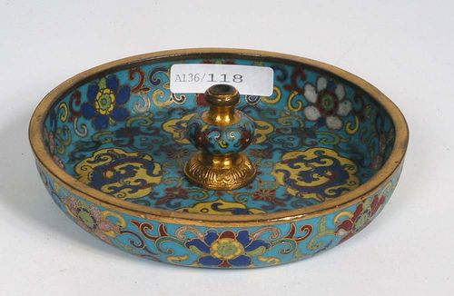 INCENSE HOLDER with a turquoise background of turquoise cloisonné enamel decoration. Between flower patterns, four cloud-shaped cartouches with stylized blue dragons on a yellow background. Gilded rims and bases. China, 1st half of the 18th century. D 11.5 cm. Berti Aschmann Collection. Cf. Gabbert Avitabile, Merchandise from the Land of the Devil, 1981, pg. 135.