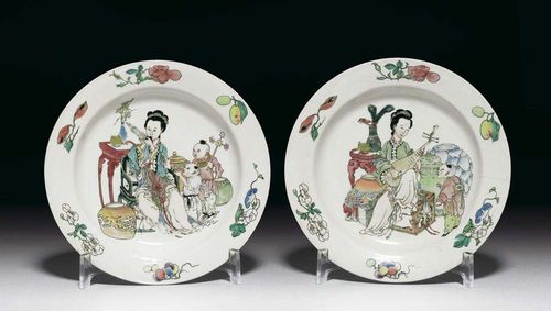 A PAIR OF DEEP DISHES with very fine famille rose decoration. A pipa player is seated among various treasures, such as vases, books, scrolls and an incense burner. The rim with individual flowers and fruits. The second plate is similar, except that the lady is playing the sheng and accompanied by two boys. The back of the rim has a raspberry-colored glaze. China, Yongzheng Period, D 20.7 cm. One plate restored, one with two hairline cracks. (2) Berti Aschmann Collection.