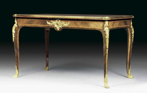 BUREAU-PLAT "AUX PATTES DE LION", Louis XV, signed F. LINKE (François Linke, 1855-1946), Paris, end of the 19th century. Tulipwood and rosewood in veneer and inlaid with reserves and fillets, the top lined with gold-stamped green leather and edged in moulded bronze, broad frontal drawer and sham drawer verso, exceptionally fine matte and polished gilt bronze mounts and sabots. 125x76x75 cm. Provenance: from a German collection