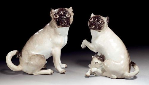 PUG DOG AND BITCH WITH PUPPY, Meissen, circa 1745-50.Model by J.J.Kändler. Both dogs seated with their heads turned to the side, the bitch with raised left paw and suckling the puppy. Naturalistically painted in grey and brown tones. Underglaze blue sword mark verso on the bitch. H 25cm and 22.5cm. Hair crack on the back of the bitch, the right front leg and right ear of the puppy and base of the dog's tail restored. Provenance: from an important private collection, Basel