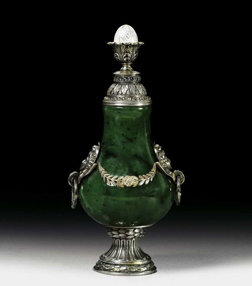 PERFUME BOTTLE. Marked St. Petersburg 1908-1917.In the style of Fabergé. Nephrite in a silver mounting. Pear-shaped body of nephrite on retracted, gadrooned round foot with two laurel wreaths. Handles on both sides. Handles set with rose-cut diamonds, connected with foliate festoons.  Palm frond frieze on top set with diamond-cut rose friezes (2 diamonds missing). H 10.7 cm.