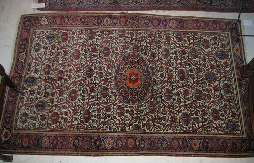 FERAHAN old. White ground with oval central medallion, patterned with stylised plant motifs in brown and blue tones, narrow dark border. Good condition. 131x204 cm.