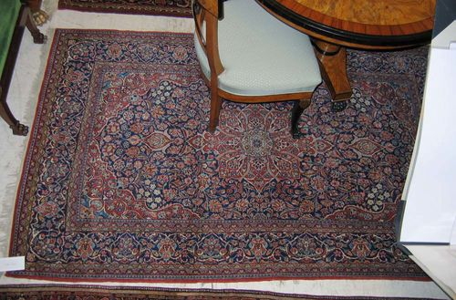 KESHAN old. Dark blue ground with red central medallion and corner motifs, trailing flowers and palmettes. Dark blue border. Good condition. 131x214 cm.