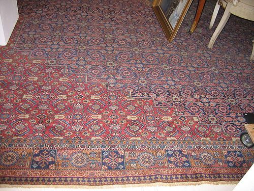 FERAHAN antique. White central medallion on dark blue ground with red corner motifs, patterned throughout with stylised flowers in harmonious colours, narrow border, good condition, 460x380 cm.