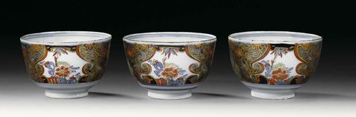 THREE CUPS WITH 'IMARI' DECORATION, Meissen, circa 1740. Painted in Imari style, with Asian style floral reserves, crossed swords and painter's mark K in underglaze-blue, impressed number 52.