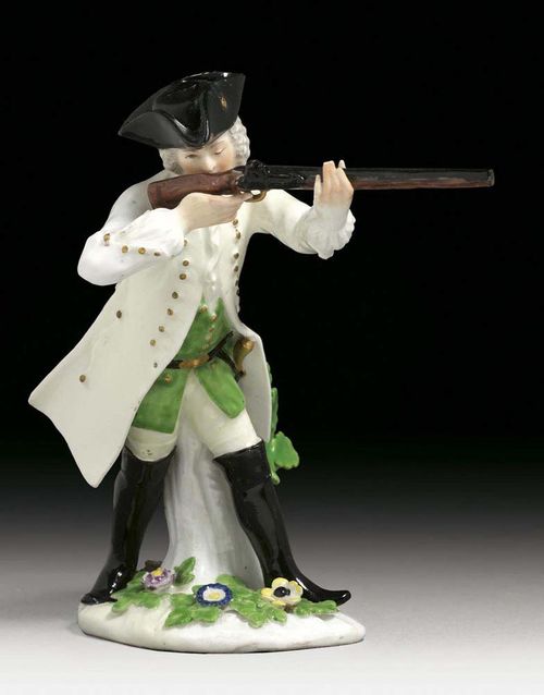 HUNTER HOLDING A GUN, Meissen, circa 1744. Standing against a tree-trunk, with his gun holding against his shoulder, crossed swords in underglaze-blue, 16cm, restored.
