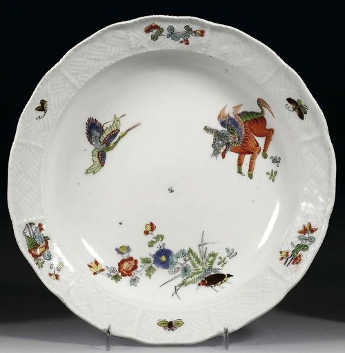SOUP PLATE WITH KAKIEMON DECORATION, Meissen, circa 1740.With 'Sulkowski' relief, painted with 'Korean Lion', heron, peonies, Indianische Blumen and insects, crossed swords in underglaze-blue, impressed number 16, D 21.5 cm. Provenance: Private collection, Solothurn.