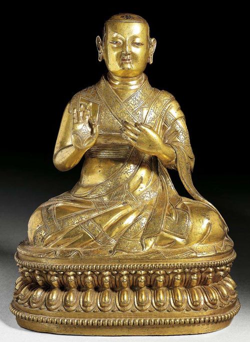 GILT BRONZE FIGURE OF AN IMPORTANT MONK. The striking facial features suggest that this is a portrait sculpture. The eyes and lips painted and the hair with remains of dark colour. Tibet, ca. 17th century.  H 22 cm.