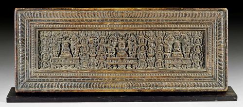A WELL CARVED WOODEN SUTRA COVER SHOWING PRAJNAPARAMITA, VAIROCANA AND AKSHOBHYA. Tibet, ca. 15th/16th c. Length 73.5 cm.