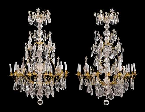 PAIR OF IMPORTANT CHANDELIERS WITH "CRISTAL DE ROCHE",Louis XV, Paris circa 1750. Matte and polished gilt bronze with exceptionally fine "cristal de roche". With 18 light branches. Fitted for electricity. H 144 cm, D 90 cm.