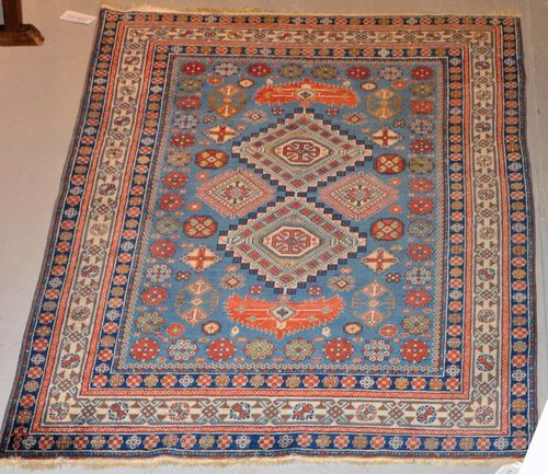 DERBEND old.With a blue ground, geometric patterning and a white border. Some light wear, 107x203 cm.