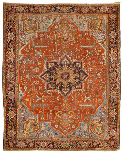 HERIZ SERAPI antique. With a black central medallion on a red ground with light blue corner motifs, patterned with stylised plant motifs in harmonious colours and with a black border. Some wear, 295x365 cm.