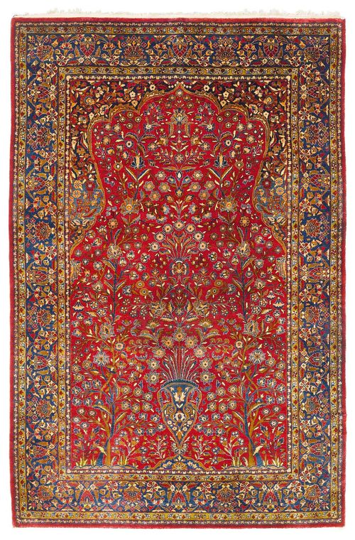 KESHAN SILK antique. With a dark red Mihrab with blue spandrels, finely patterned with floral motifs in harmonious colours. Blue border. Good condition, 136x205 cm.