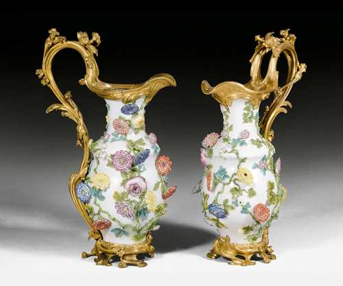 PAIR OF LARGE PORCELAIN CARAFES WITH BRONZE MOUNT,Louis XV, the porcelain from the Meissen factory, the bronze Paris, 18th/19th century. Porcelain applied with fine, polychrome painted flowers and leaves, with matte and polished gilt bronze. Restorations. H 63 cm.