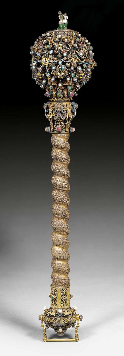 IMPORTANT SCEPTRE,Renaissance, probably Transylvania circa 1600 and later. Round shaft with wooden core and exceptionally fine, frieze-style depiction of the Battle of Szigetvar, as well as parcel gilt and enameled silver demons, mascarons and volutes. Ball-shaped head with enameled copper core, parcel gilt and enameled silver ornaments, set with precious and semi-precious stones such as rubies, emeralds, diamonds, turquoise and pearls, the silver top with Old Hungarian inscription "Den Maertyrern von Sigethvar 1566" and small female figure with Hungarian costume and child. L 64 cm. Provenance: from a private collection, Switzerland. Possibly the scepter offered here was made on behalf of the Austrian Emperor and King of Hungary as a gift to the family of Count Zrinski.