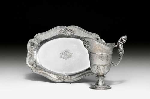 EWER AND BASIN, FROM THE ESTATE OF THE DUKE OF BOUILLON, Paris, circa 1725.Maker's mark: Etienne Guyard. Assay master Fernier Charles Cordier. The basin and the ewer with crowned coat of arms of the Duke of Boullion. H ewer 26.5 cm. L basin 44 cm. Total weight: 2758 g. Provenance: Private collection, Zurich.