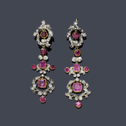 RUBY, SAPPHIRE AND DIAMOND EAR PENDANTS, ca. 1880. Silver and yellow gold. Very decorative, long ear pendants, each of 1 flexibly mounted row of leaf and flower motifs set with 7 large fine rubies of different sizes and pink sapphires, weighing ca. 7.00 ct, in settings which are closed on the back, and additionally set throughout with ca. 130 old European cut diamonds weighing ca. 3.00 ct. One ruby replaced. L ca. 7.5 cm.