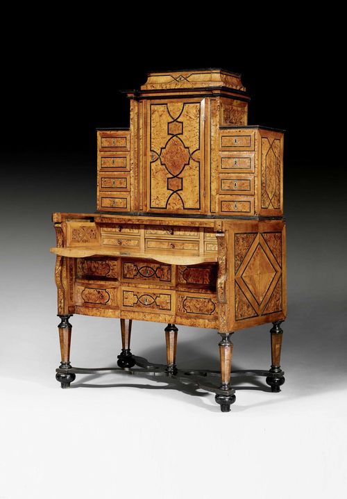 SECRETAIRE WITH UPPER SECTION,known as a "bureau a gradin", Baroque, Liege circa 1720. Walnut, burlwood, sycamore and local fruitwoods in veneer with fine inlays and partly ebonized. The "en arbalete" front with hinged top drawer - opening to writing compartment - above 2 drawers. The interior fitted with 6 drawers in 2 rows. The middle drawer hinged and usable as writing support. Recessed upper section with large door with marquetry decoration similar to writing surface, also on inside, flanked by four drawers. Narrow drawer at the top. Central locking. Bronze mounts. 108x62x(open 74)x190 cm.