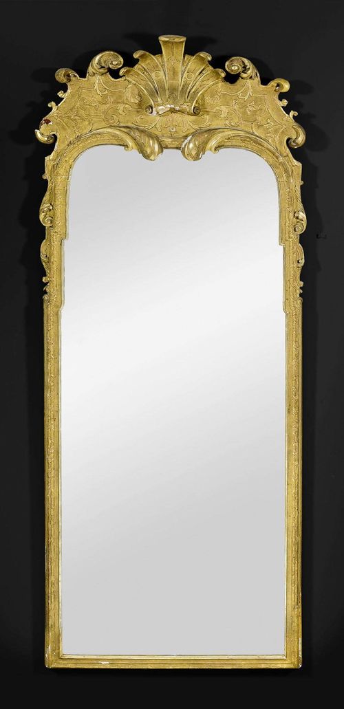TALL MIRROR,Baroque, German circa 1720/40. Pierced, richly carved and gilt wood. Some chips. H 215 cm, W 80 cm.