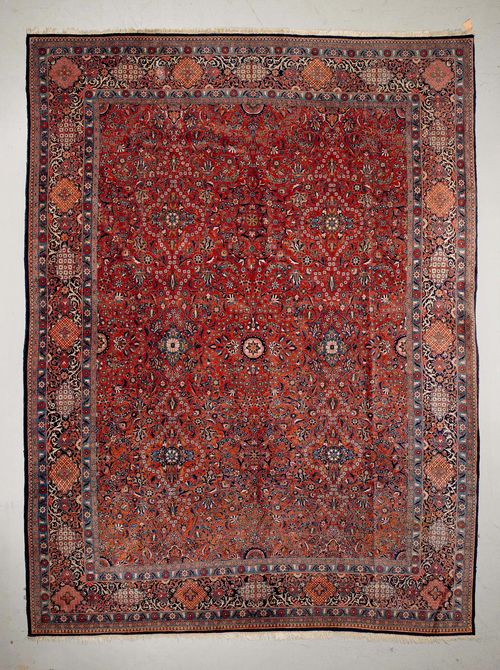 KESHAN old.Rust coloured central field patterned throughout with trailing flowers and palmettes, blue edging with floral cartouches, slight wear, 308x420 cm.