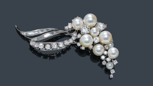 A PEARL AND DIAMOND BROOCH, E. MEISTER, circa 1950. White gold 750. Set with 9 Akoya cultured pearls and circa 33 brilliant-cut diamonds of a total of ca. 1.50 ct, and 12 baguette-cut diamonds of a total of ca. 0.40 ct and 10 brilliant-cut diamonds of a total of ca. 0.50 ct. Signed Meister. L ca. 6 cm.