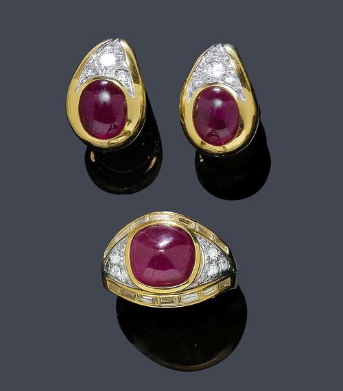 A RUBY AND DIAMOND RING WITH EAR CLIPS, E. MEISTER. Yellow and white gold 750. The ring set with 1 ruby cabochon of ca. 6.40 ct, paved with 12 brilliant-cut diamonds of a total of 0.40 ct, and 14 baguette-cut diamonds of a total of ca. 0.80. Size ca. 49, with adjustment insert. Matching ear clips set each with 1 ruby cabochon of a total of ca. 6.00 ct and 4 brilliant-cut diamonds of a total of ca. 0.55 ct.
