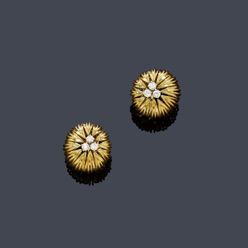 GOLD AND DIAMOND EAR CLIPS, VAN CLEEF & ARPELS, ca. 1960. Yellow gold 750, 17g. Classic, button-shaped, open-worked ear clips designed as stylized flowers, each with the centre decorated with 3 brilliant-cut diamonds, total diamond weight ca. 0.70 ct. Signed VCA Made in France, barely legible No. 3V 231.3.
