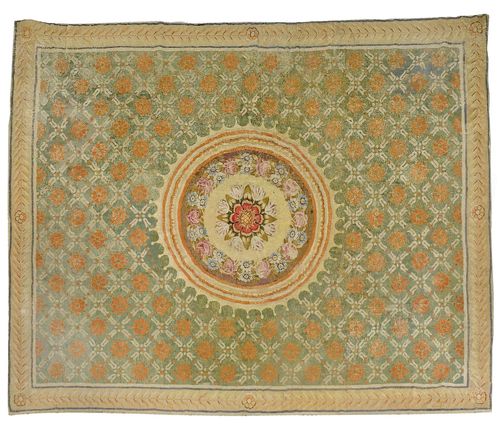 AUBUSSON antique.Green central field with a beige central medallion, patterned with stylized blossoms and flower garlands in attractive pastel colours, beige edging, signs of wear, 380x430 cm.