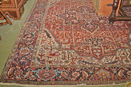 HERIZ old.Red ground with a black central medallion and white corner motifs, typically patterned, black edging, 265x355 cm.