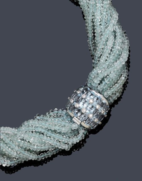 AQUAMARINE AND DIAMOND NECKLACE/TORSADE. Clasp in white gold 750. Casual-elegant, 17-row necklace of numerous facetted aquamarine beadlets. Fancy, convex clasp set with 18 oval aquamarines weighing ca. 7.00 ct and additionally decorated with 14 brilliant-cut diamonds weighing ca. 0.30 ct, in a collet setting. L ca. 45 cm.