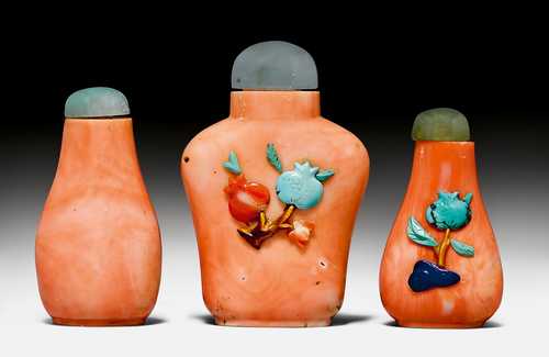THREE SMALL CORAL SNUFF BOTTLES WITH STONE OVERLAY DECORATION OF POMEGRANATES.