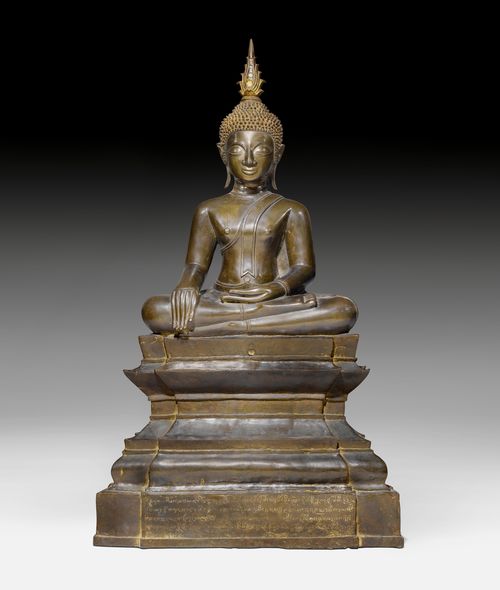 A BRONZE FIGURE OF BUDDHA SHAKYAMUNI SEATED ON AN A HIGH THRONE.