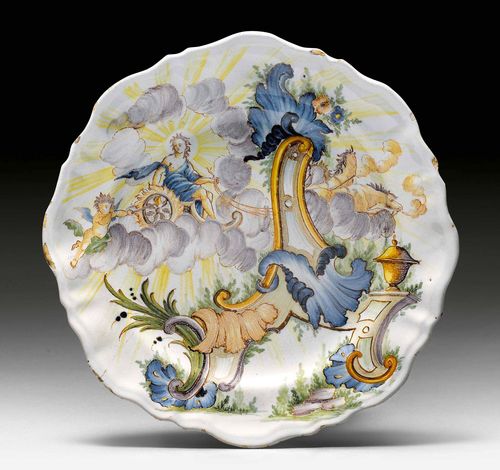 RARE PLATTER, Turin, Fabbrica Rossetti, ca. 1750. Depicting the Sun God Helios on his chariot, accompanied by a putto blowing air towards the fire under the wheels. D 24.5 cm. Small hairline crack.