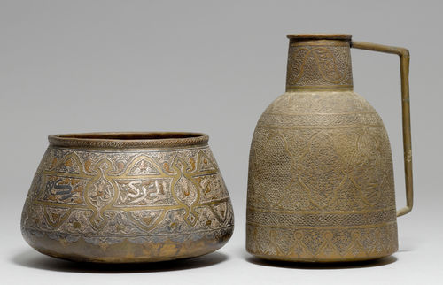 A LOT OF TWO BRASS VESSELS: A MAMLUK-REVIVAL BASIN WITH SILVER AND COPPER INLAYS AND AN ENGRAVED PITCHER.