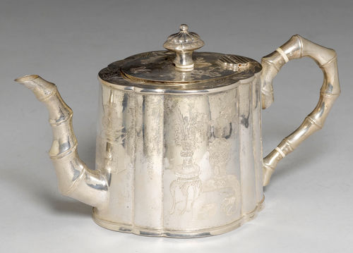 A LOBED SILVER TEAPOT WITH AN ENGRAVED AND PUNCHED DESIGN OF SCHOLARS’ OBJECTS, THE HANDLE AND SPOUT SHAPED AS BAMBOO.