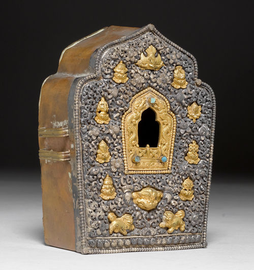 A PARCEL-GILT SILVER G'AU WORKED IN HIGH RELIEF WITH TIBETAN BUDDHIST EMBLEMS.