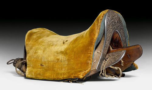 A FINE WOOD SADDLE WITH PIERCED AND GOLD DAMASCENED IRON PLATES.