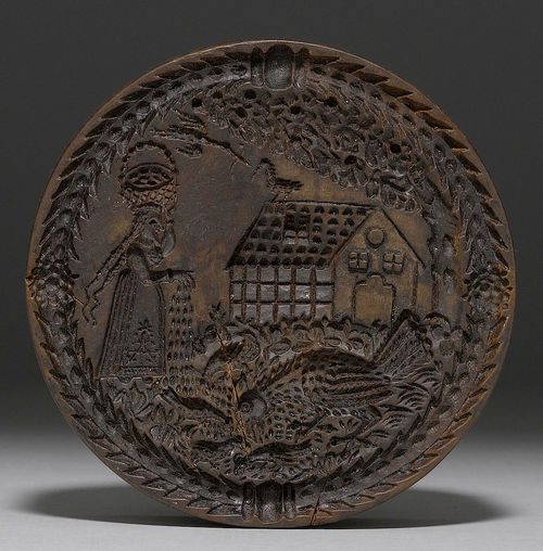 BAKING MOULD WITH DEPICTION OF A WOMAN FEEDING HENS.