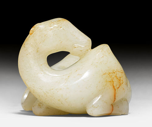 A FINE WHITE AND RUSSET JADE CARVING OF A RECUMBENT CAMEL.
