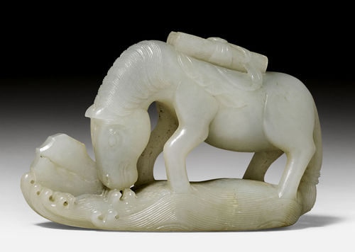 A CELADON JADE FIGURE OF A DRINKING HORSE BEARING SCROLLS ON THE BACK.