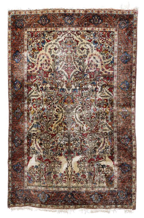 KESHAN SILK antique.Beige ground, opulently patterned with depictions of plants in harmonious colours, violet edging, tear to be restored, 125x195 cm.