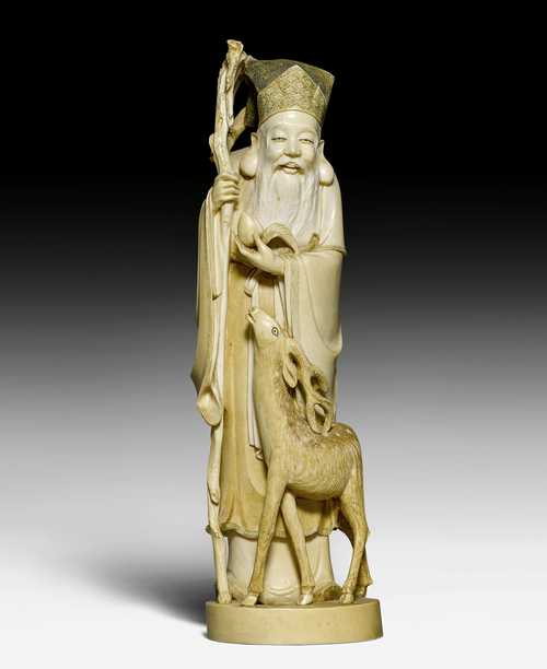 AN IVORY FIGURE OF JUROJIN WITH A SMALL DEER AND PEACH OF IMMORTALITY ON A PEDESTAL.