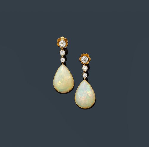 OPAL AND DIAMOND EAR PENDANTS. Yellow gold and platinum. Decorative, elegant ear pendants with studs, each of 1 very fine, drop-cut opa,l weighing ca. 20.00 ct in total, flexibly suspended below a line of 3 old European-cut diamonds, weighing ca. 1.10 ct in total. With case.