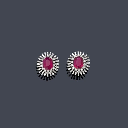 RUBY AND DIAMOND EAR CLIPS. White gold 750. Decorative, elegant ear clips with studs, set with 1 oval ruby of 5.68 ct and 5.23 ct, respectively, each within a border of 24 baguette-cut diamonds and 14 brilliant-cut diamonds, total diamond weight ca. 4.10 ct. With GRS Report No. GRS2011-040080T and 82T, April 2011. Matches the following lot.