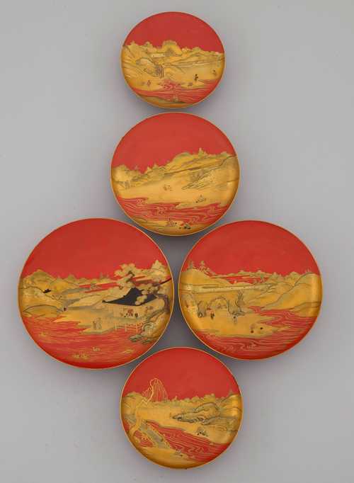 FIVE RED LACQUER SAKE BOWLS WITH LANDSCAPES IN HIRA- AND TAKA MAKI-E, AND KIRIKANE. Japan, 19th c. D 14 to 20 cm. Minor damage. (5)